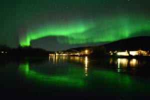 Green Northern Lights show over Rundhaug Gjestegård in Norway