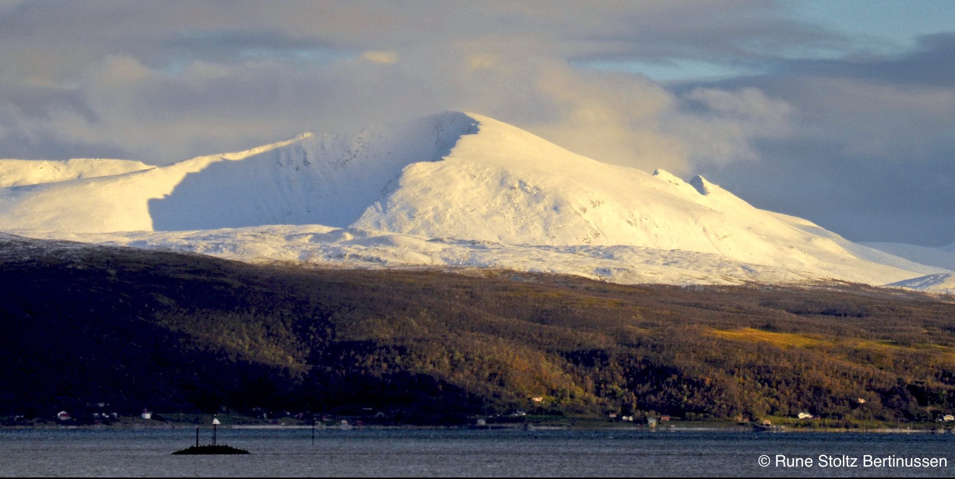 Arctic Norway snowy mountain on cloudy clear day