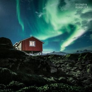 northern lights above rorbuer fishermens cabin autumn in svolvaer lofoten islands norway