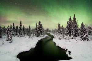 northern lights aurora borealis with snow lake trees