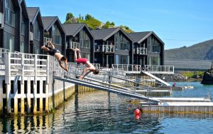 summer in Senja Norway people jumping into the water