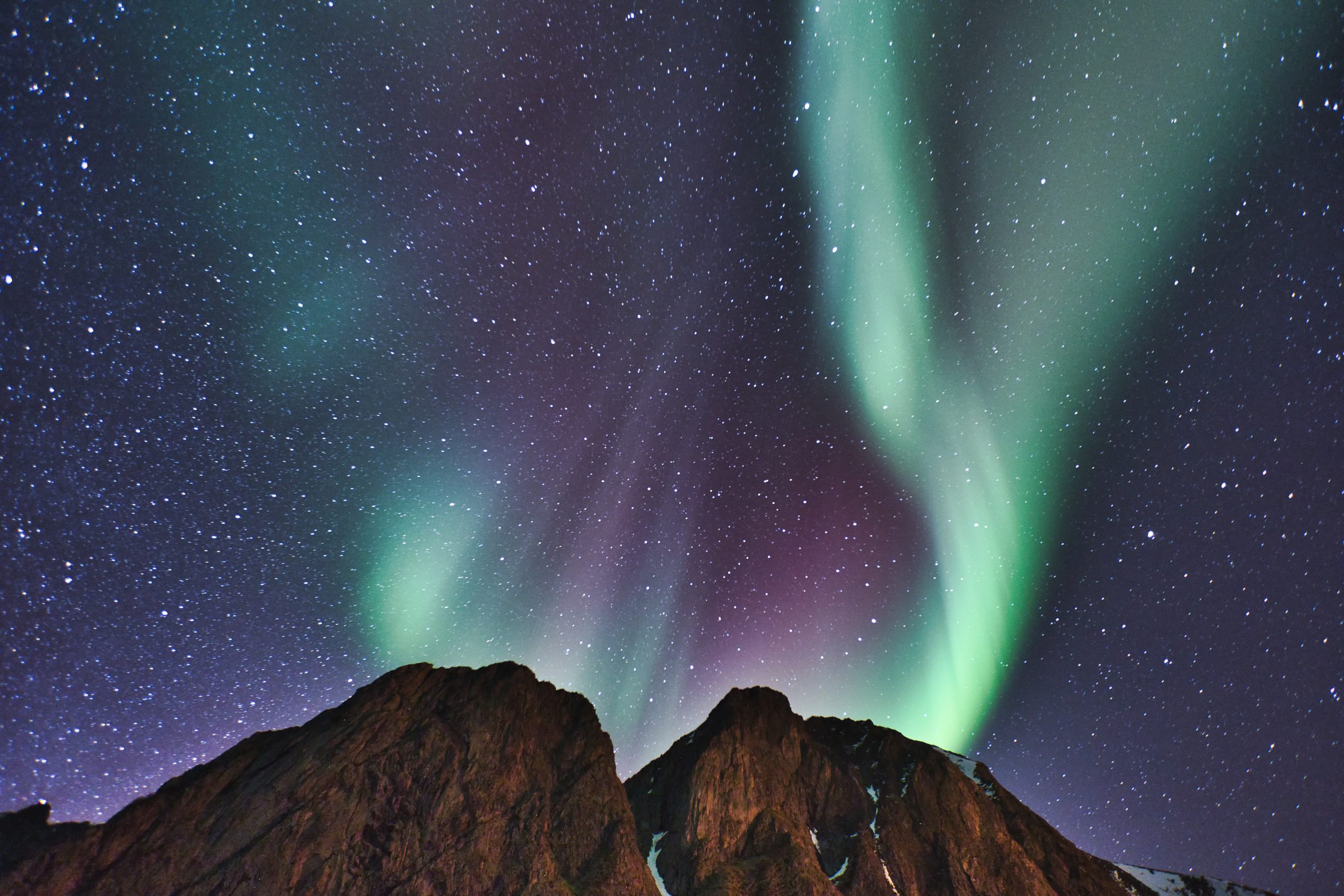 northern lights aurora over fjords mountains